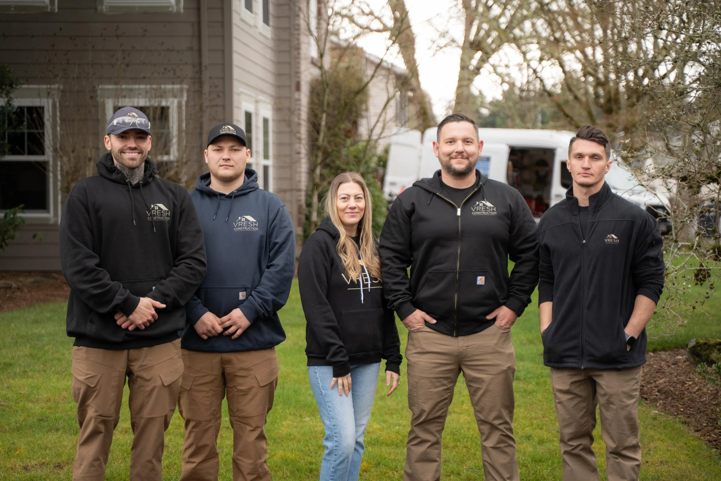 VResh Construction team standing together on the front lawn of a home