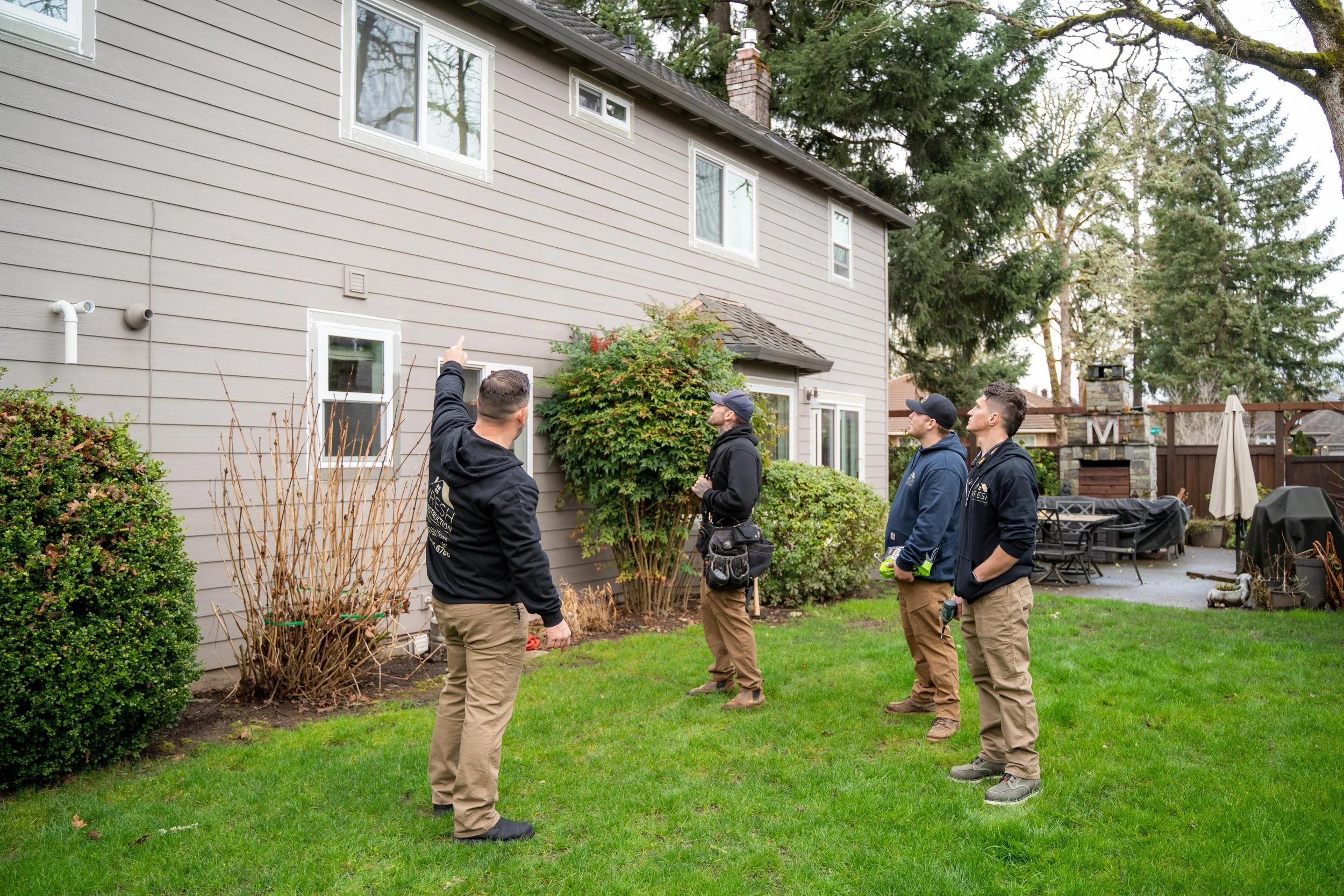 VResh Construction crew walking the back yard of a Portland home