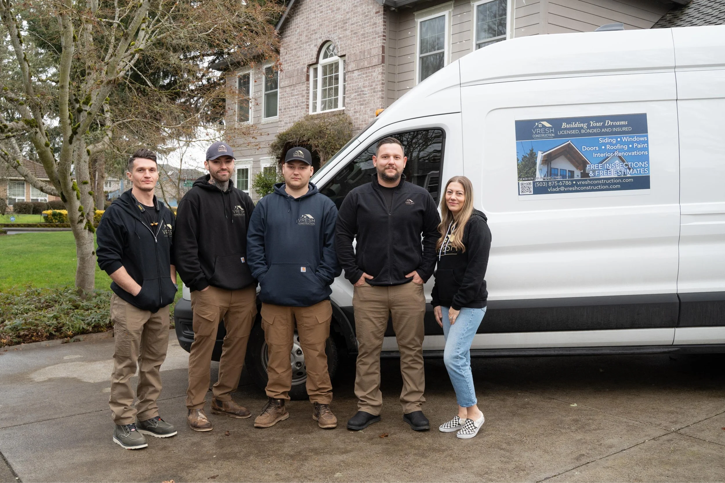 VResh Construction team standing beside the company van in front of a Portland home
