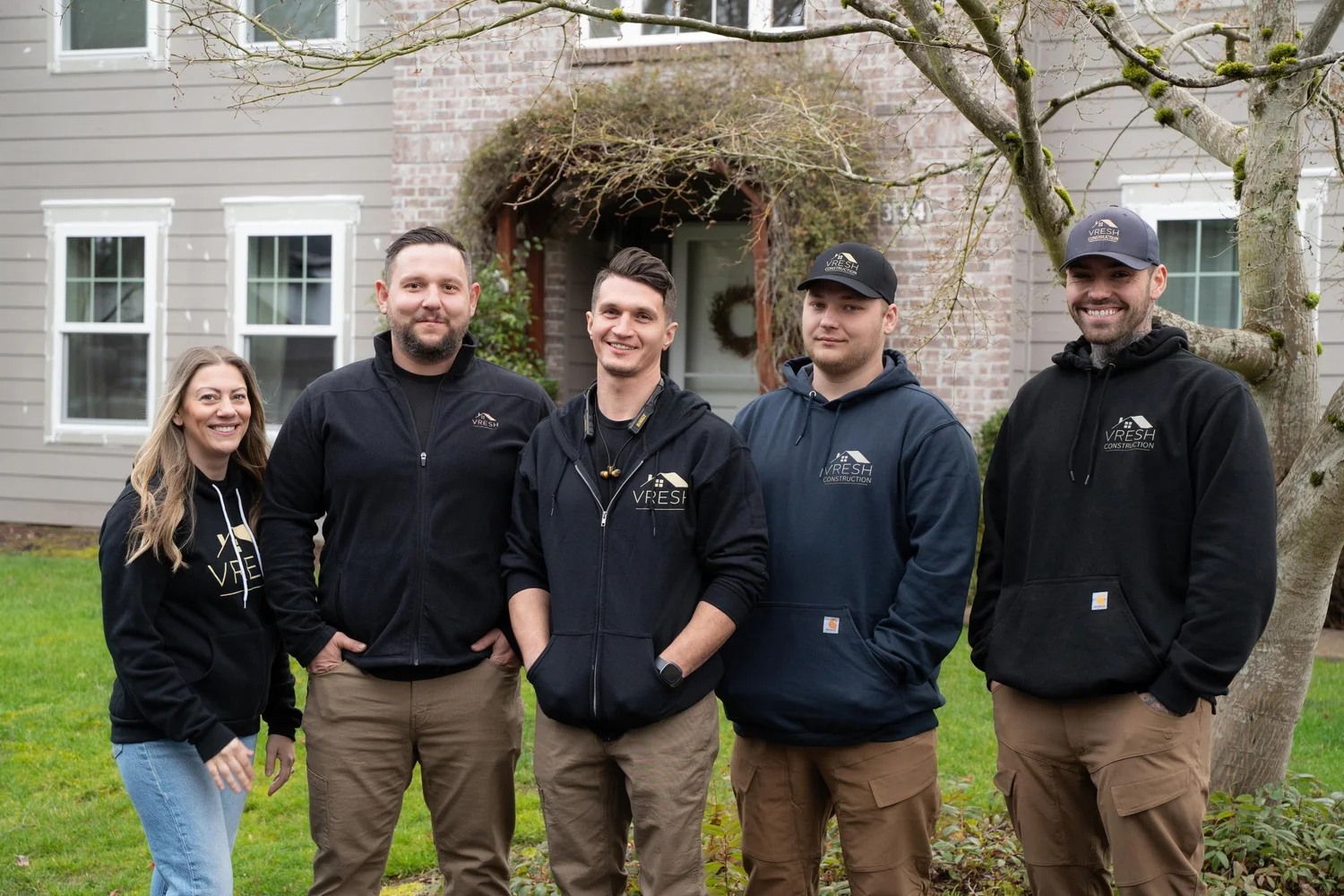 VResh Construction team standing together in front of a Portland home