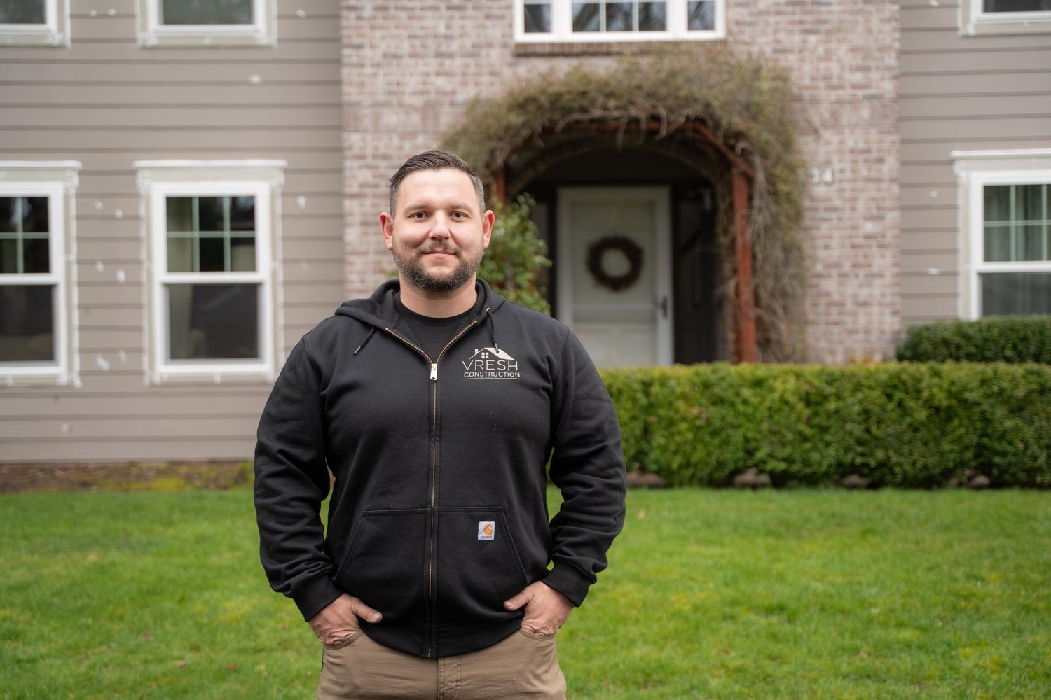 Vlad, owner of VResh Construction, standing in front of a Portland home