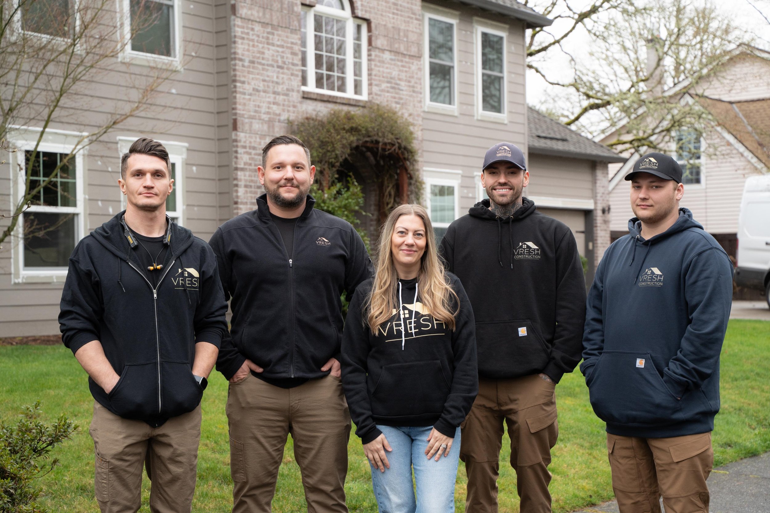 VResh Construction team standing together on the front lawn of a home