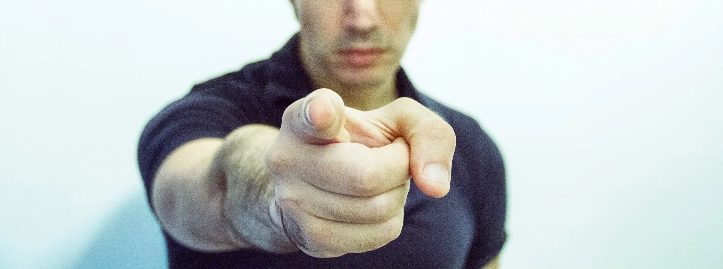  (Stock photo of a man pointing in an accusatory manner.) 