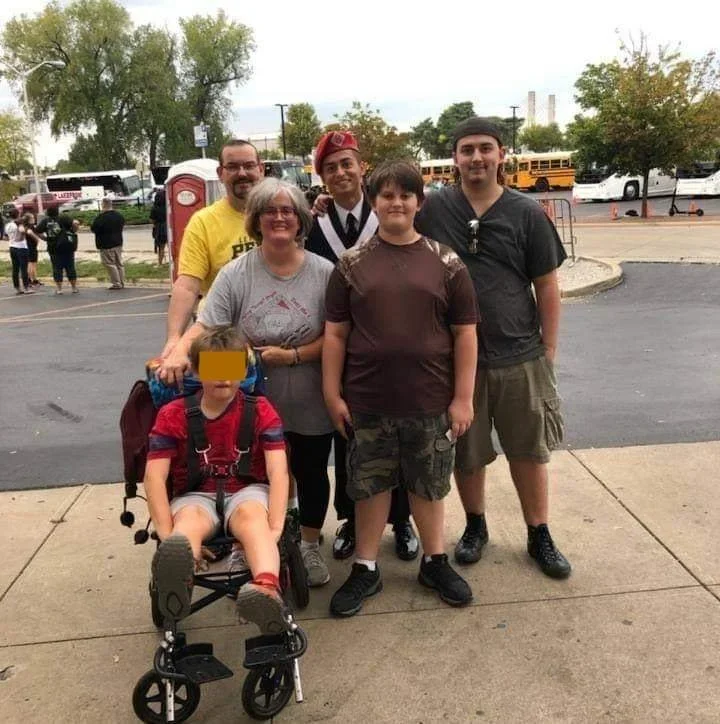  The family likes to take walks when the weather is nice, with their dog. S gets to ride on his adaptive bike, while they push him along.  