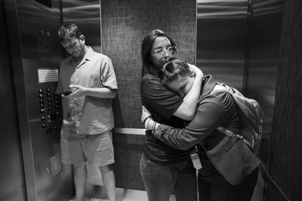 In the elevator, Jackie pulls Jadyne into a close hug.