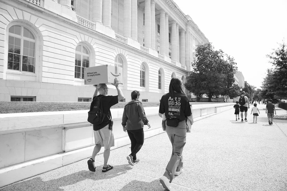 Outside the Capitol, a father balances a box on his head as the group walks to thank the Capitol Police.