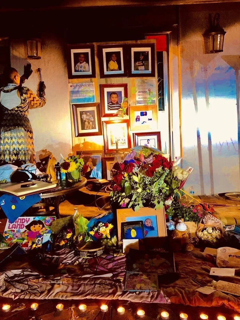  Photos, flowers and tributes in front of the scorched home of autism advocate Feda Almaliti and her son Muhammed. 