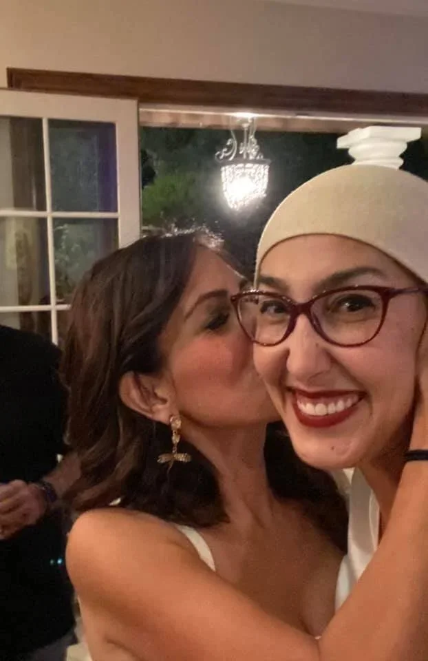  An ebullient Feda being kissed by her friend Saba Torabian the night before her passing. 