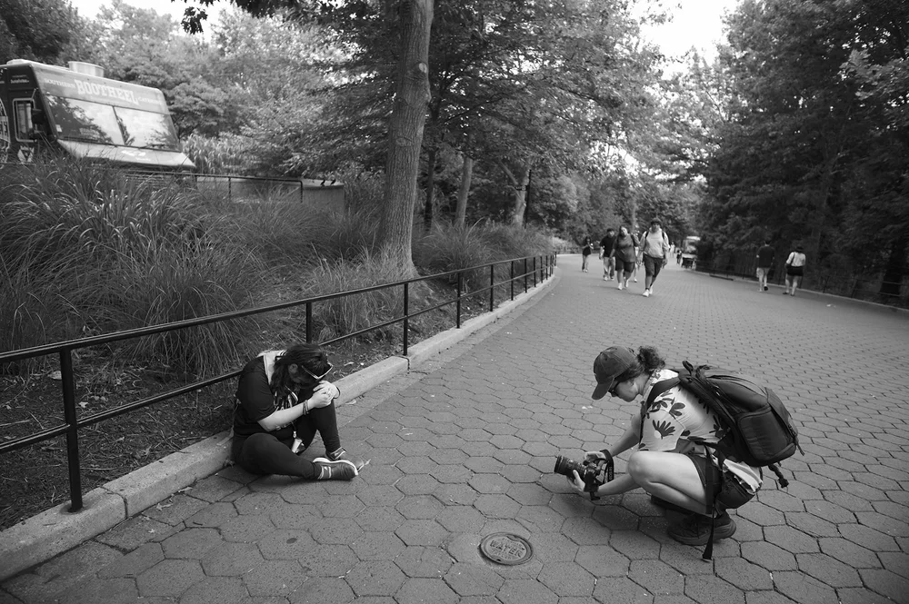 At the zoo, Jadyne sits to gather herself as a documentary crew member gives her space.
