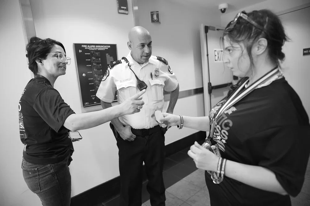 Jadyne shows Jackie the stickers she just received from the Capitol Police.