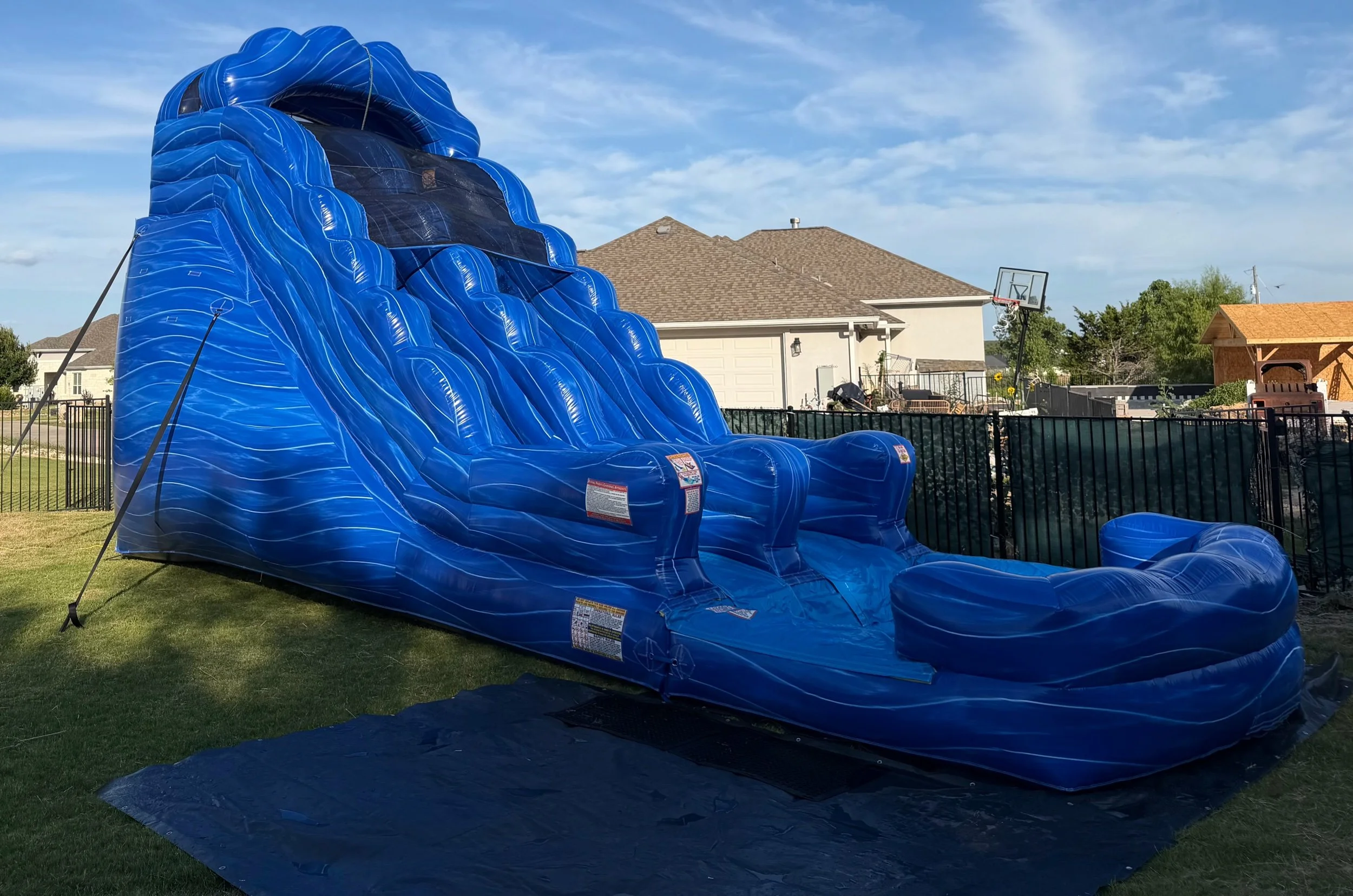 Blue Tidal Wave Water Slide set up by Hill Country Celebration Rentals