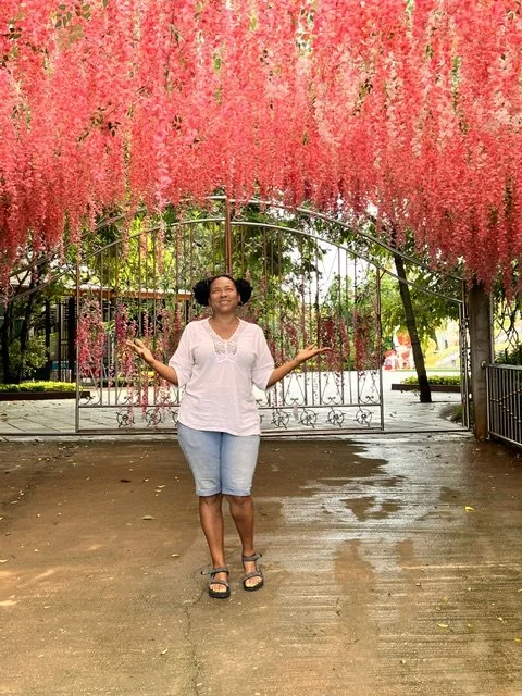 Sondra under pink flowers Thailand