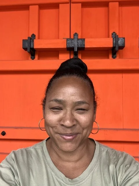 Sondra at the orange temple door Japan