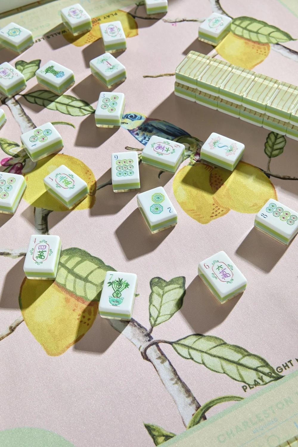 Oh My Mahjong Palm Royale mahjong tiles at the table: Palm Royale on the Oh My Mahjong Citrus Songbird mat · photo: Oh My Mahjong