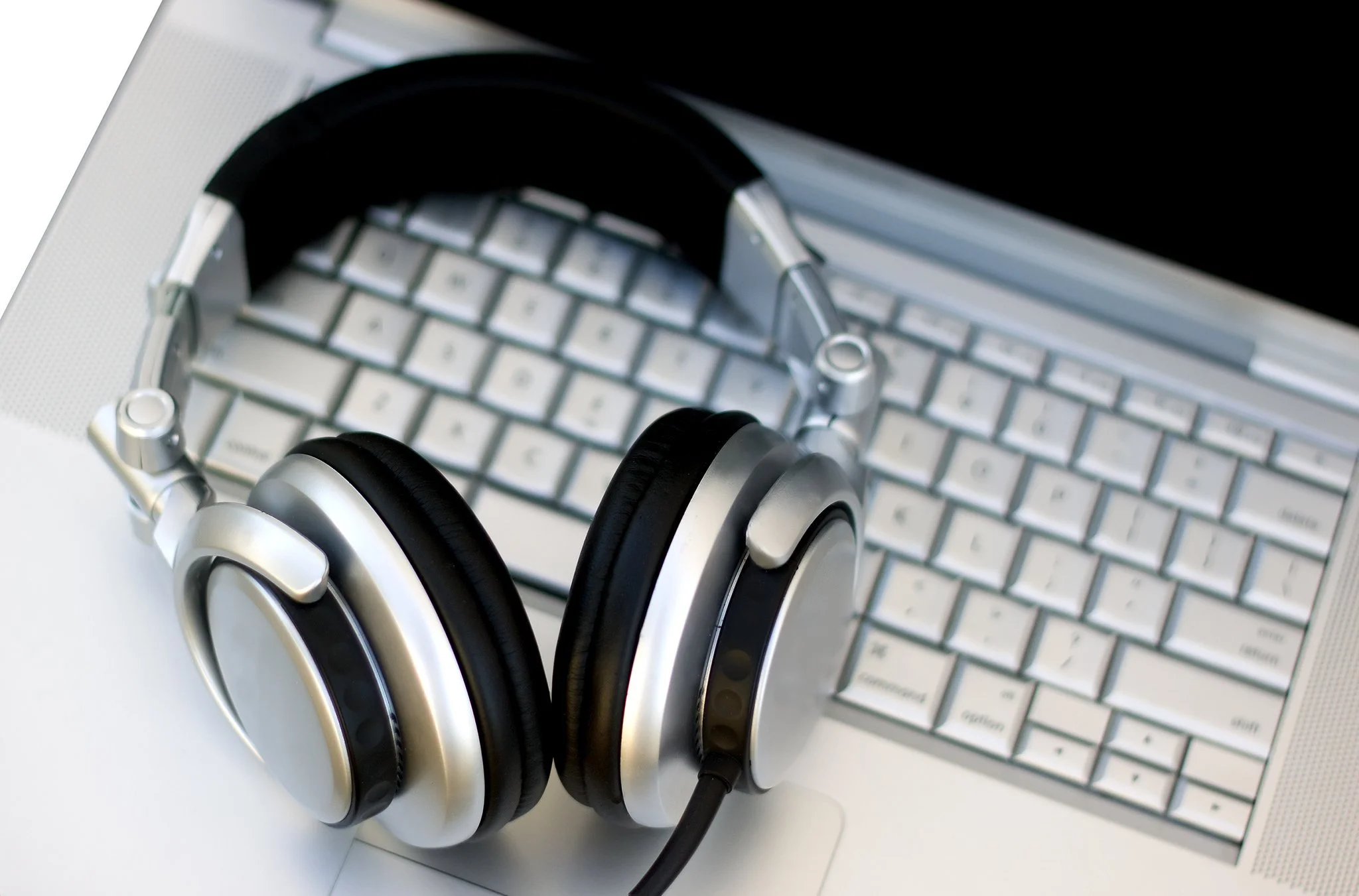 Professional transcription setup with headphones and laptop