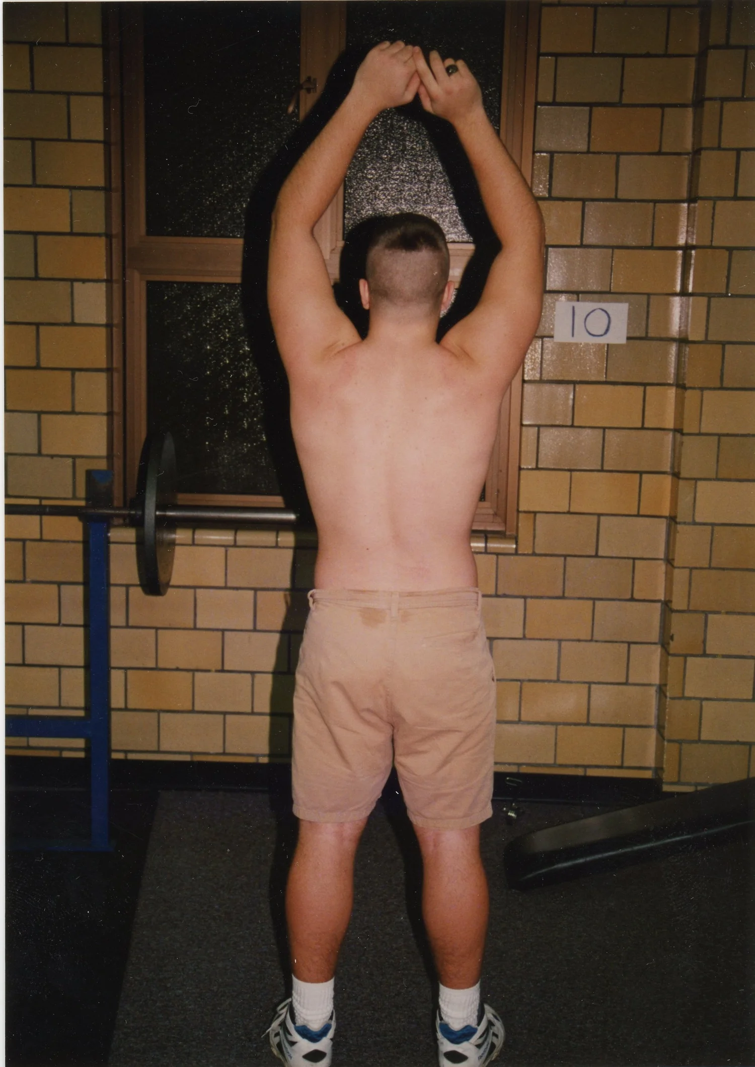 Archival photograph, overhead flex with hands together