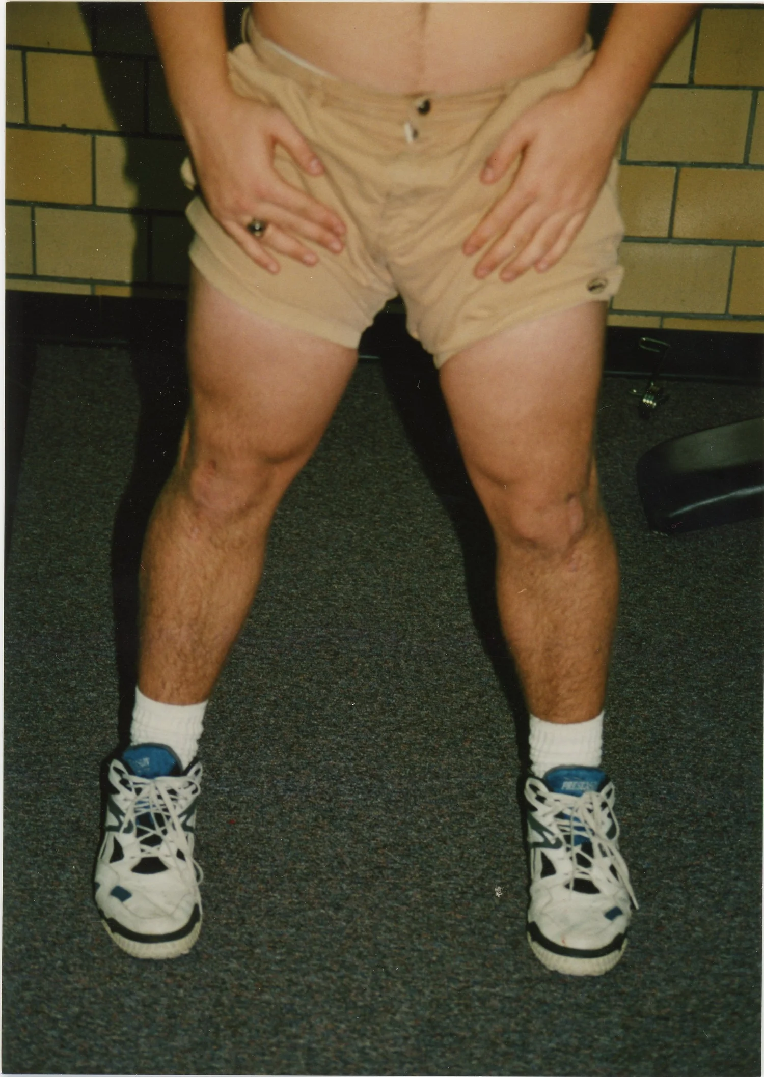 Archival photograph, cropped legs and body