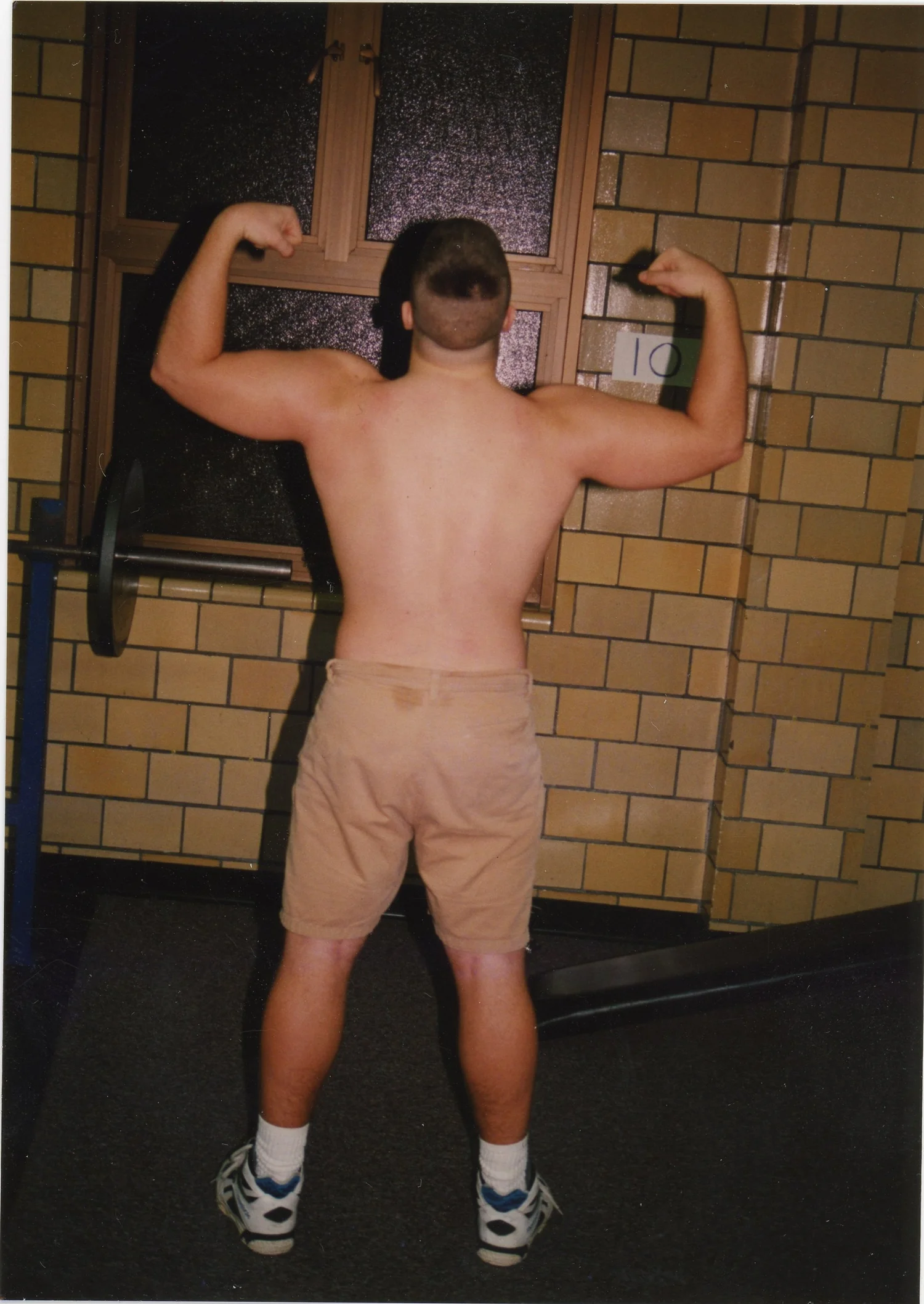 Archival photograph, double-biceps flex with handwritten 10