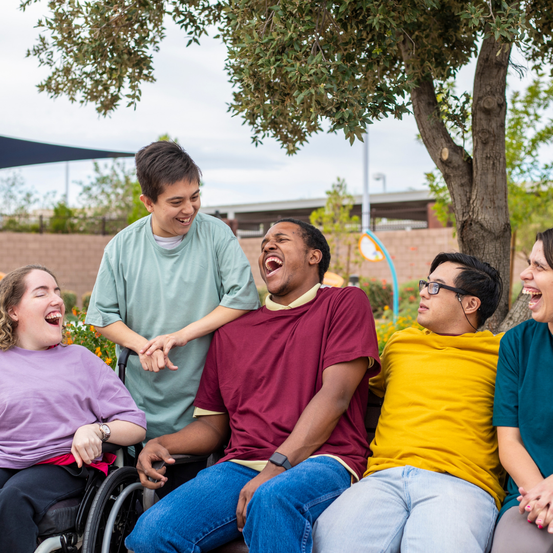 A group of friends sharing a laugh outdoors