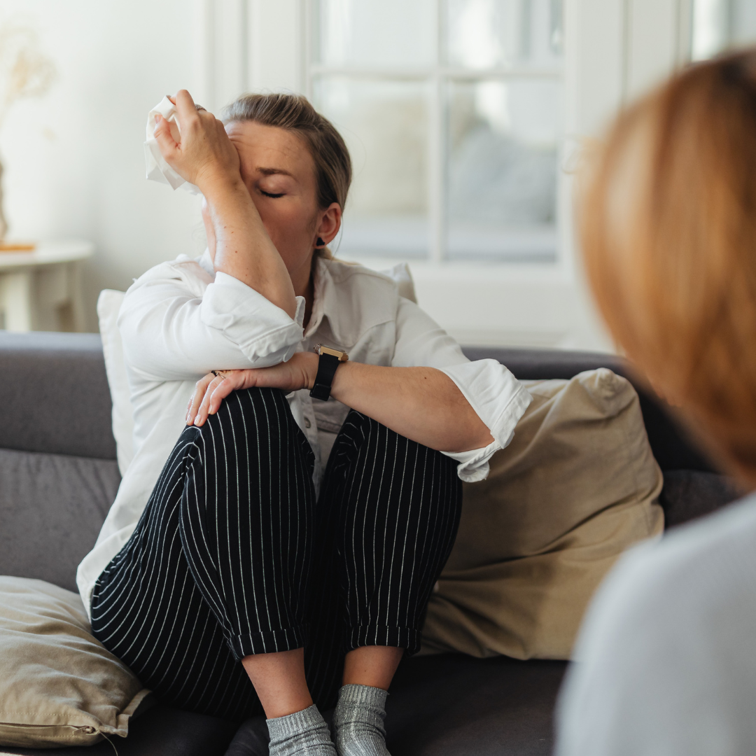 A woman sharing difficult feelings during a counselling session.
