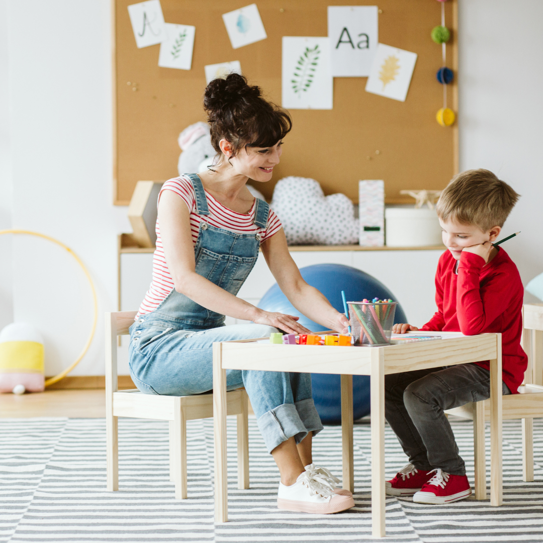 A child and adult working on a creative activity.