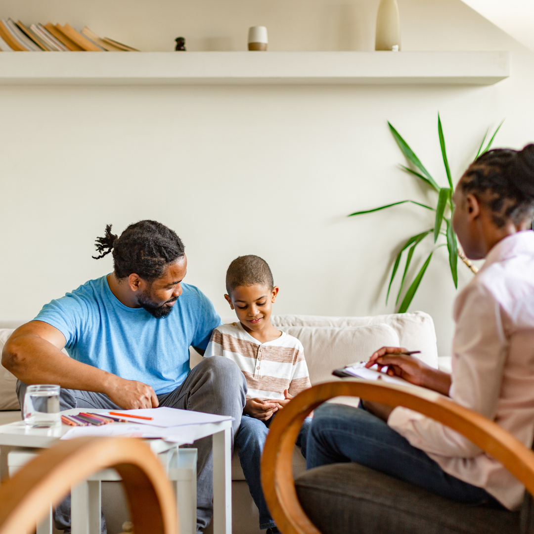 A parent and child talking with a professional.