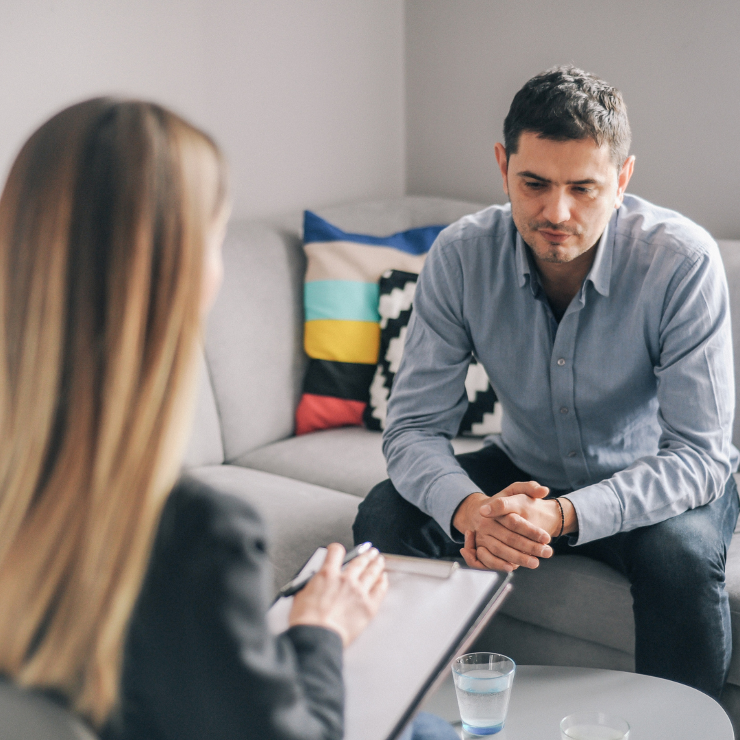 A man speaking with a counsellor.