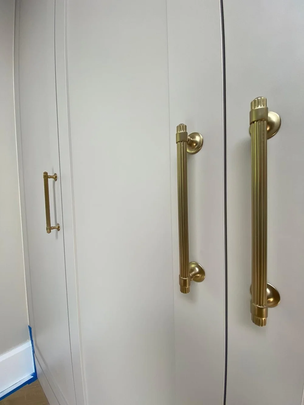Bespoke painted wardrobe with brass handles in a Morden house renovation