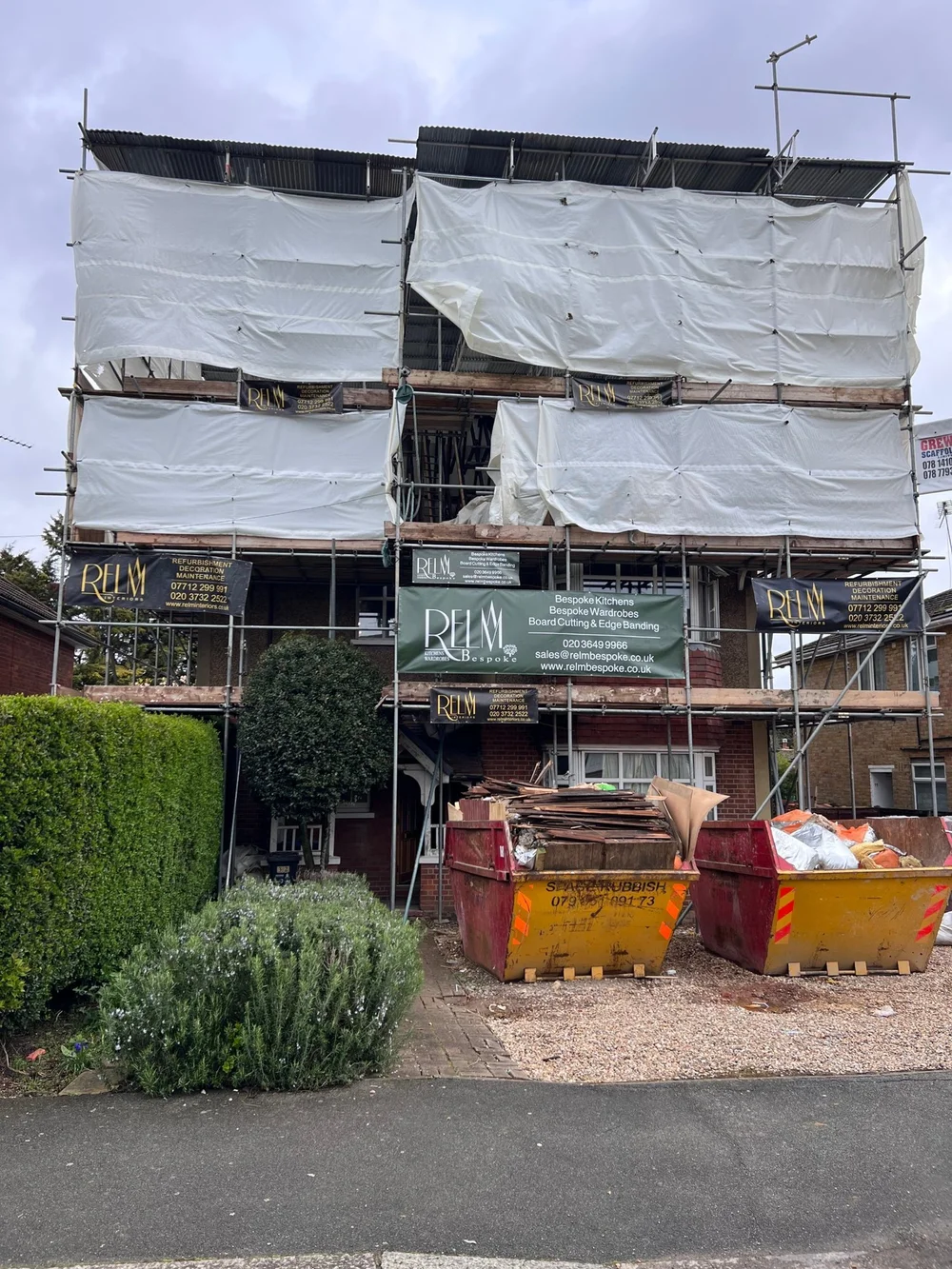 Wimbledon house under scaffold with RELM Interiors and RELM Bespoke banners at the start of the works