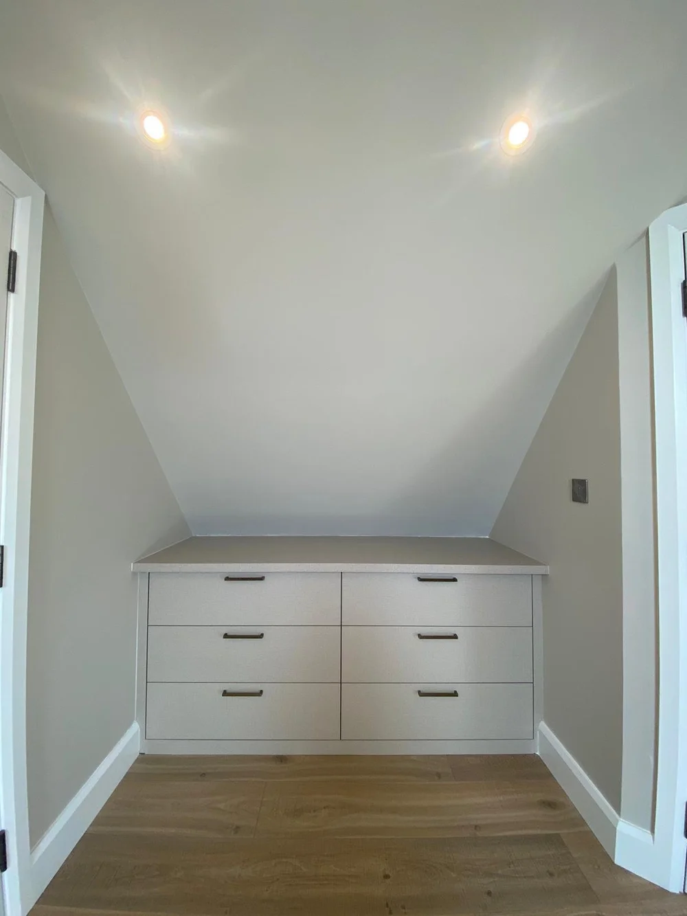 Bespoke drawers built under the eaves of a Wimbledon loft by RELM Bespoke