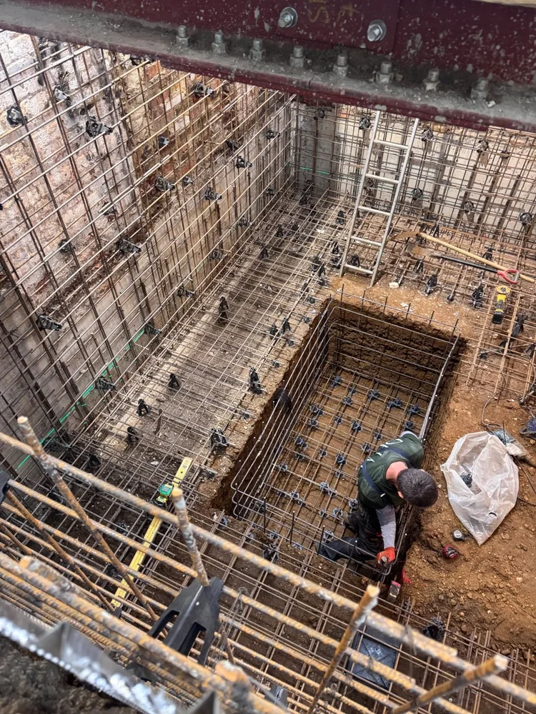 Basement walls and slab with reinforcement in place, by RELM Interiors