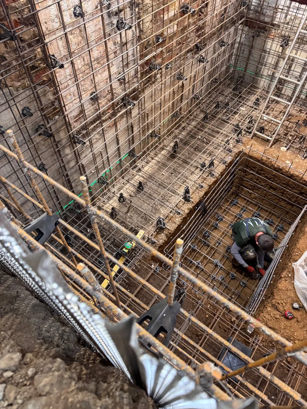 RELM Interiors team fixing reinforcement for a new basement slab