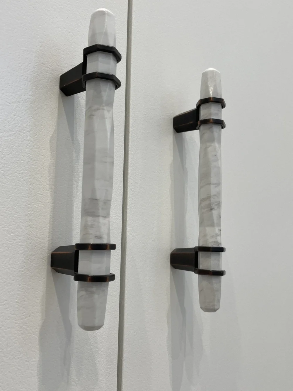 Marble and bronze handles on bespoke hallway cabinetry in Wimbledon