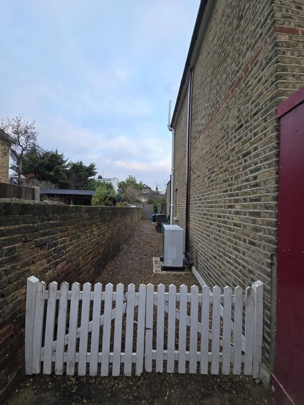 Heat pump installed beside a Victorian cottage in SW19 in place of the boilers