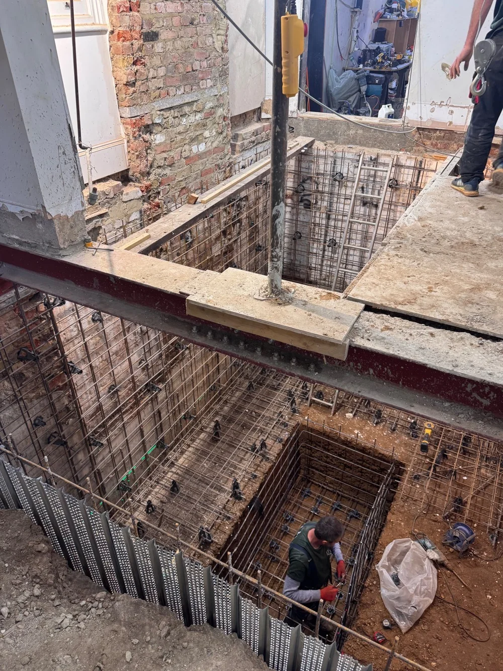 Basement excavation with steel beams and reinforcement in a London house, by RELM Interiors