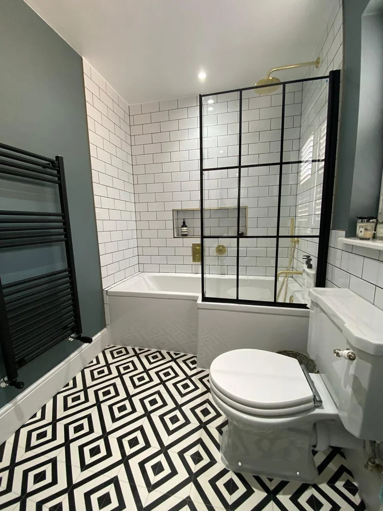 Bathroom with Crittall-style bath screen in Fulham by RELM Interiors