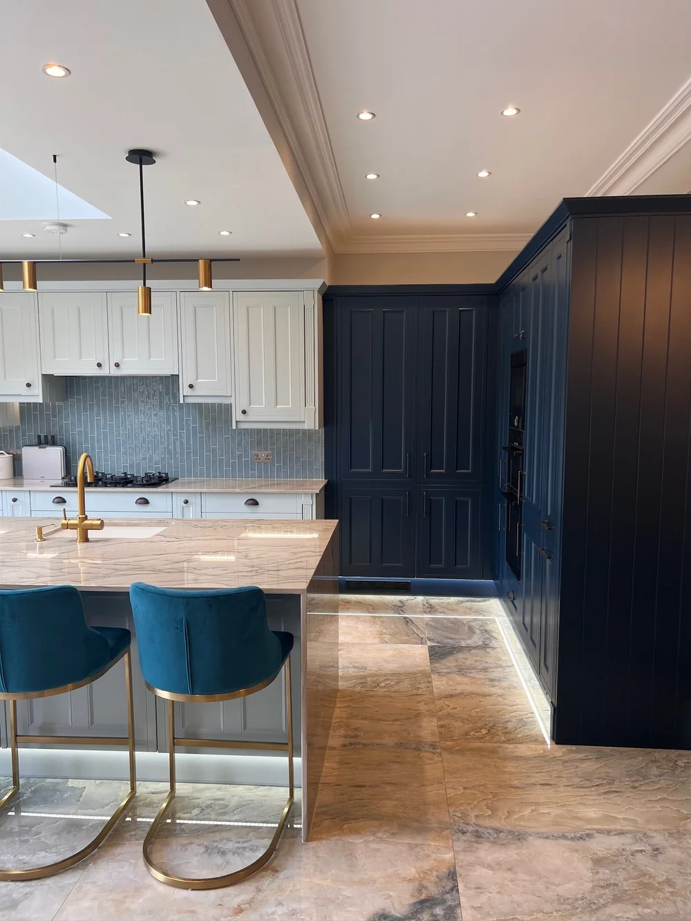 Navy tall kitchen units in a 1930s house renovation in Wimbledon