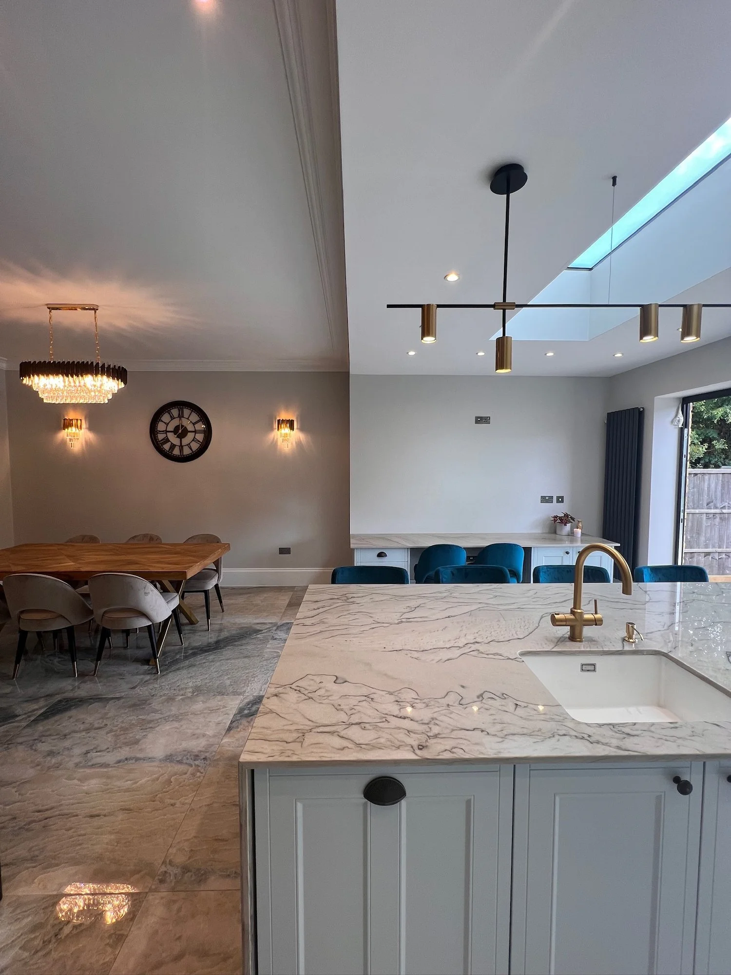 Kitchen and dining area with marble floors in the rear extension of a Wimbledon house renovated by RELM Interiors