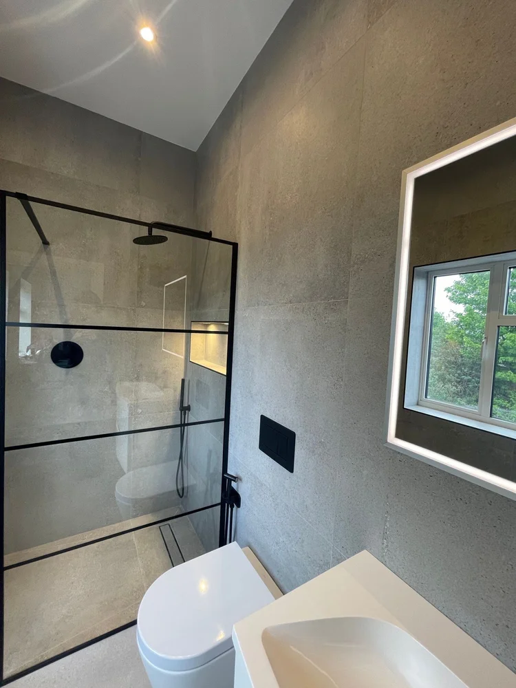 Shower room with Crittall-style screen in Wimbledon by RELM Interiors