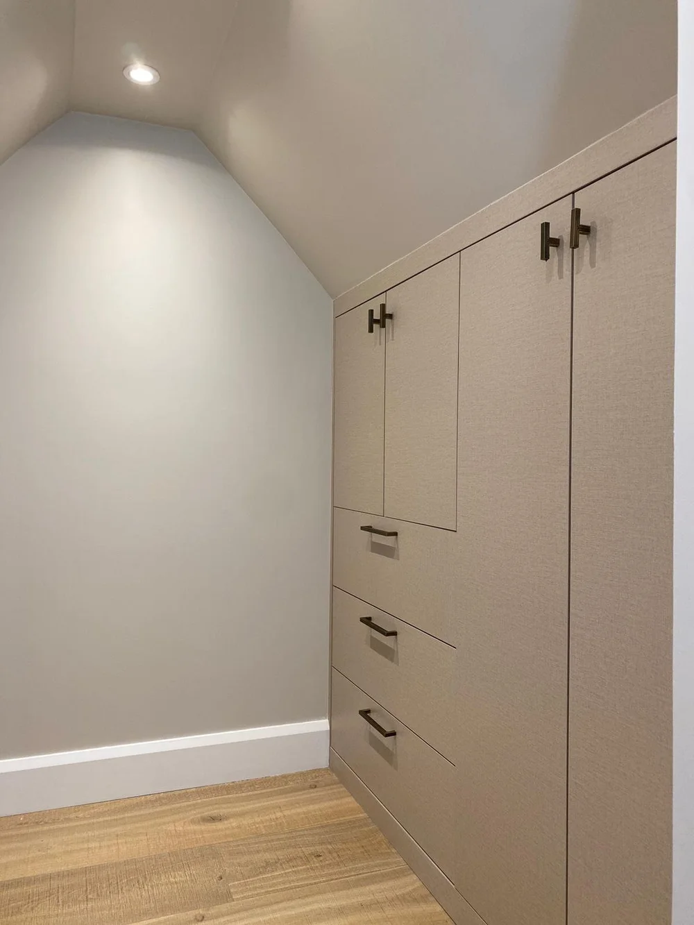 Bespoke walk-in wardrobe under the roof slope in Wimbledon, made by RELM Bespoke