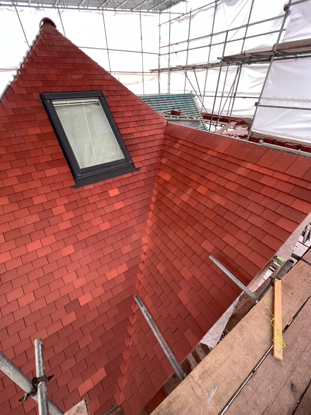 Red clay tile roof with a new roof window on a Wimbledon house renovated by RELM Interiors