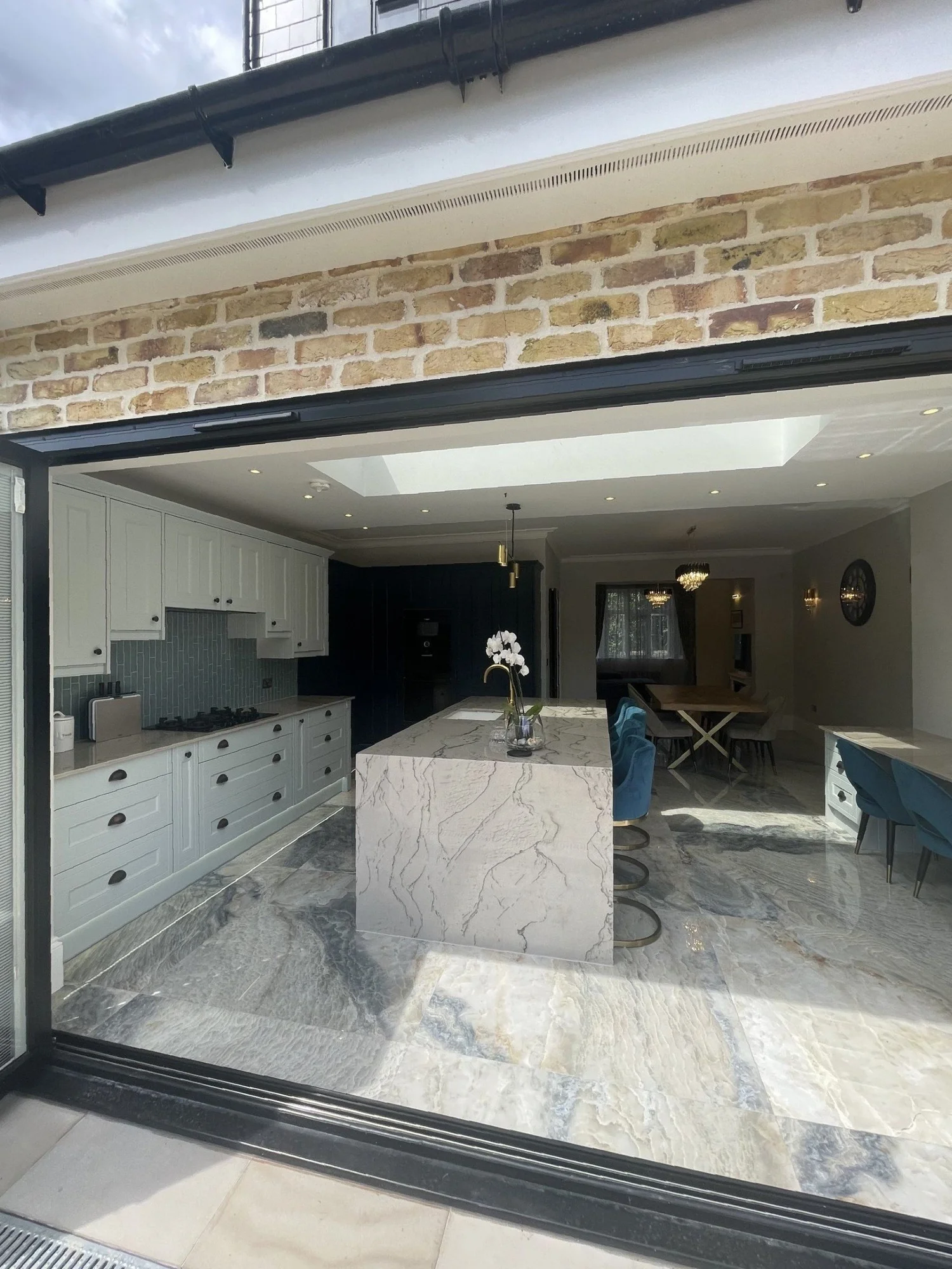 Rear extension with bifold doors opening onto a stone patio in Wimbledon, built by RELM Interiors