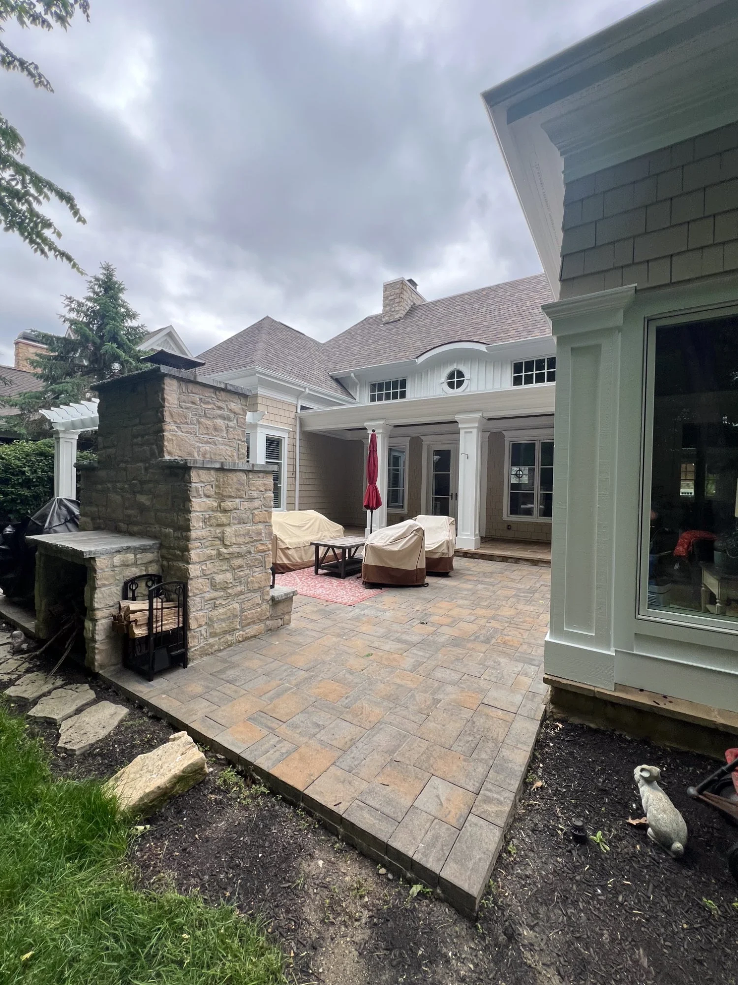 Paver patio with stone outdoor fireplace