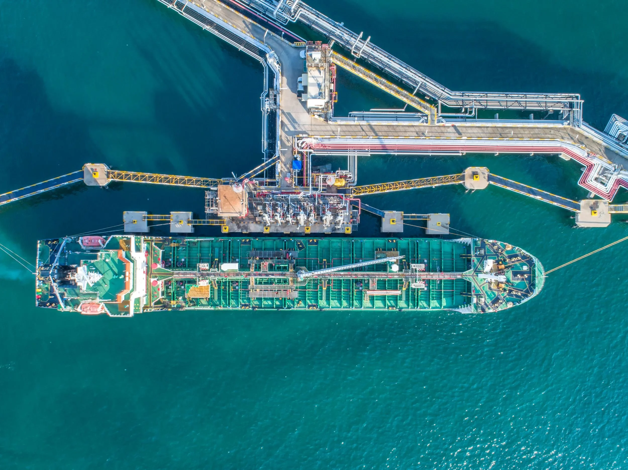 Cargo ship alongside a port at dusk — technology-specific communications