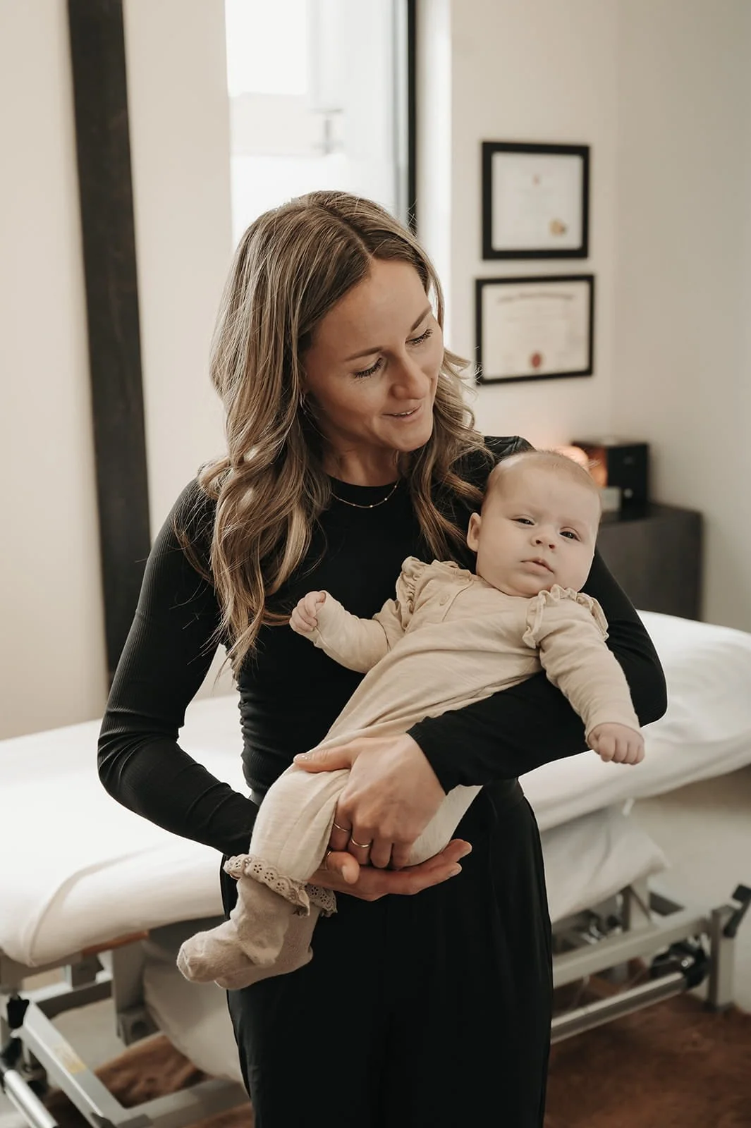 Kensey Lunn performing osteopathic care on a newborn