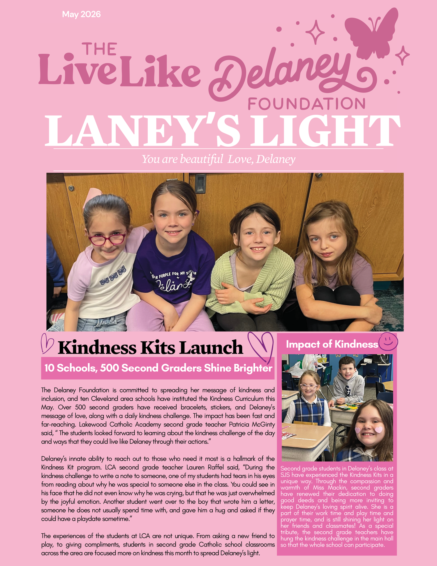 Four smiling girls sitting together in front of wooden cabinets, one in a purple Delaney shirt