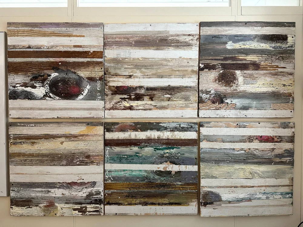 Six Jupiter Series paintings displayed together on a wall
