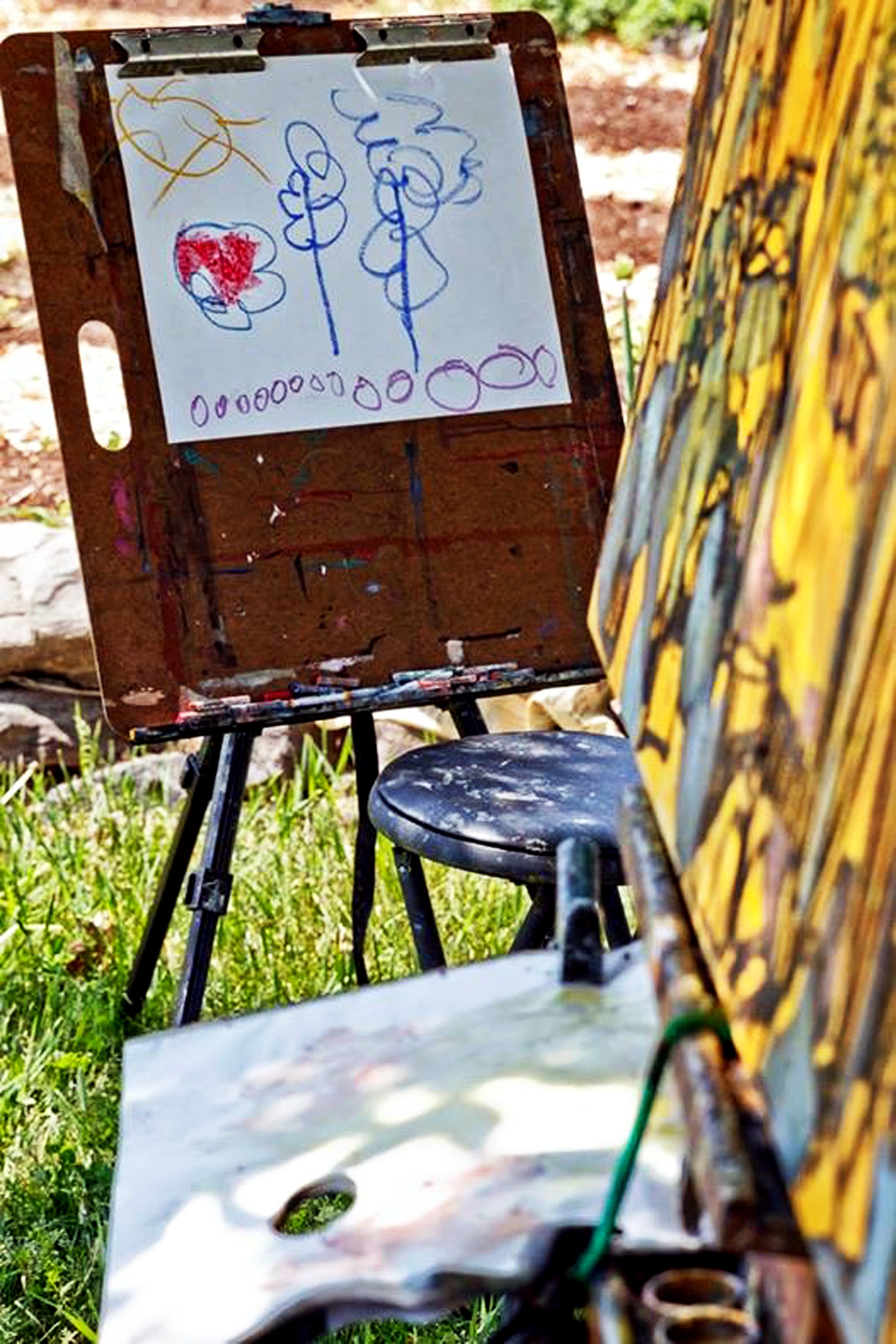 A drawing beside the garden painting on its easel.