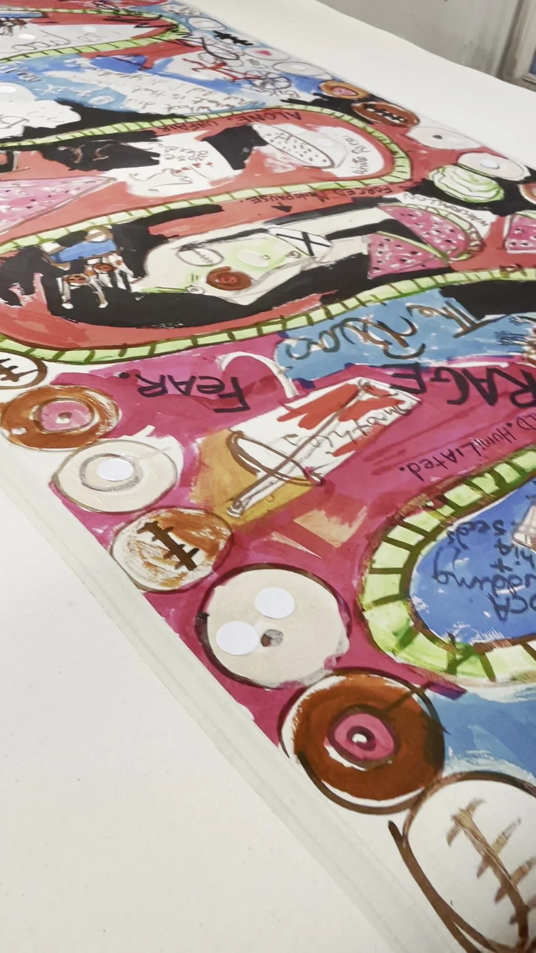 Studio detail of Cancer Rollercoaster, showing painted figures, looping tracks, and circular elements along the edge.