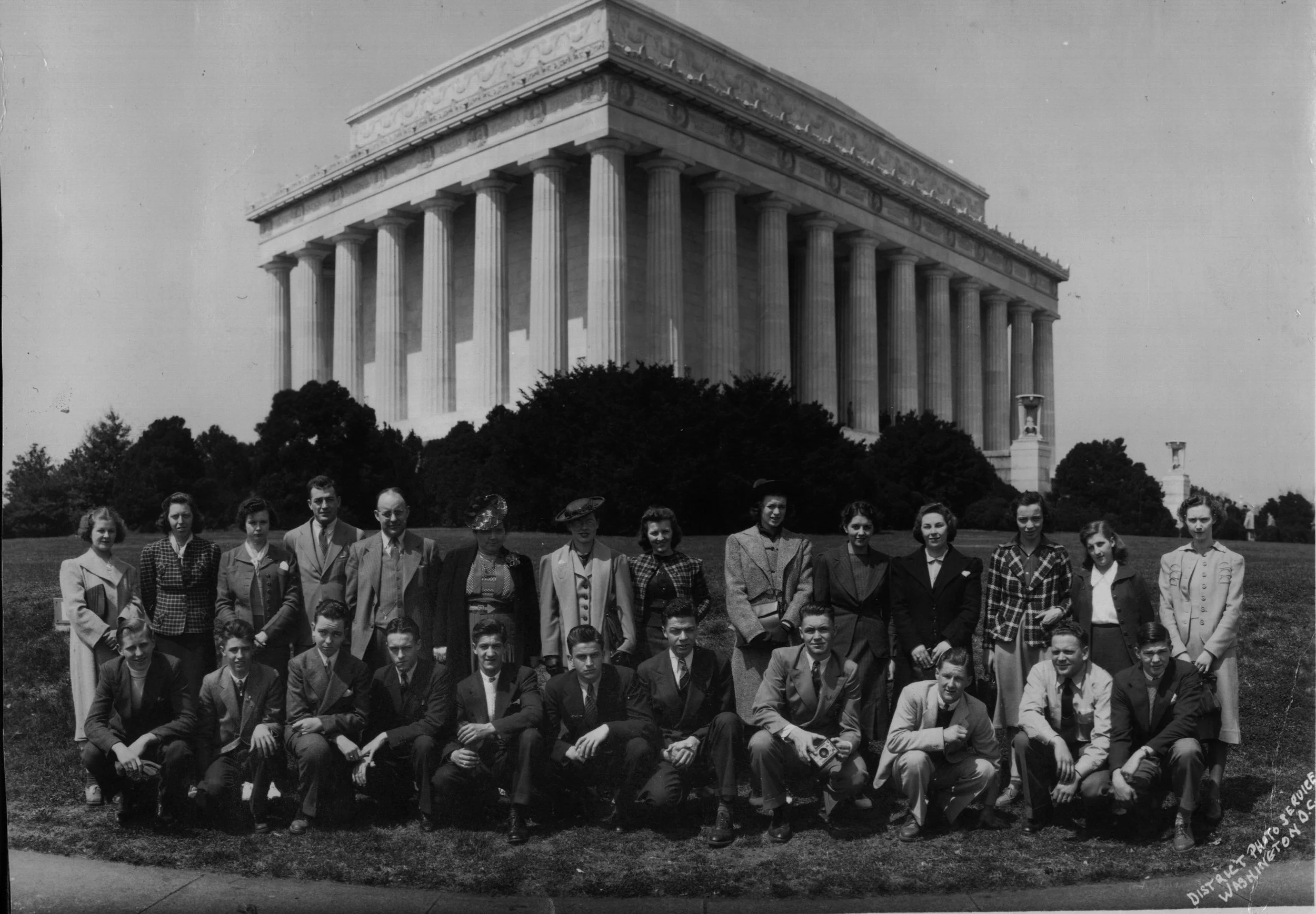 Student group portrait on the Lincoln Memorial steps with the memorial's grand columns in the background, Washington, DC. Central Photo Company